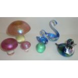 Seven pieces of iridescent glass including three graduating mushrooms