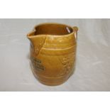 Large brown glazed tavern jug inscribed 'E.