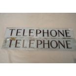 Two rectangular glass telephone signs