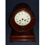 Mahogany cased mantel clock with white enamel dial on stepped base with French striking movement