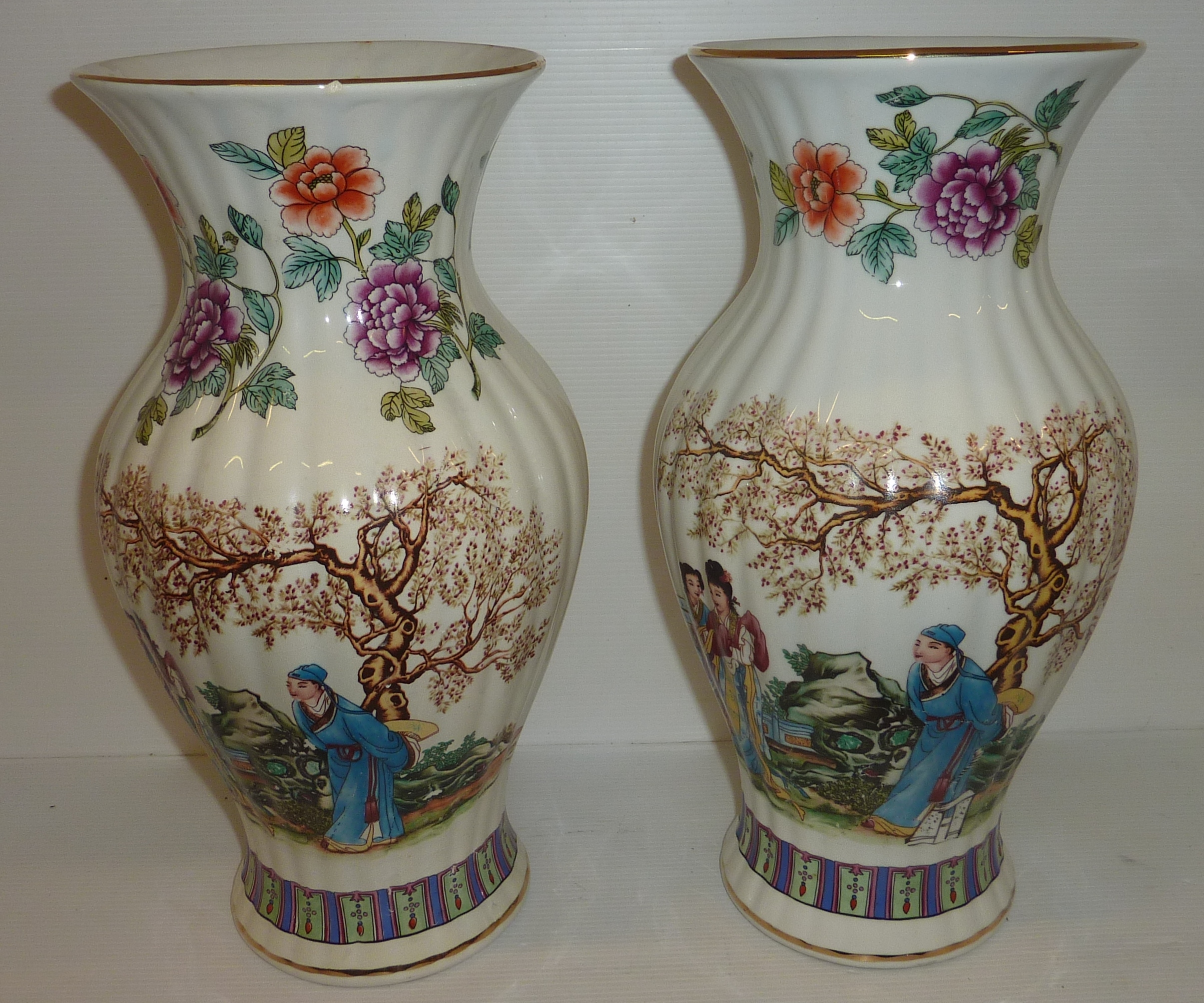 Pair of modern ribbed Chinese vases with floral and figural patterns