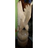 Large wood carved figure of an eagle with out stretched wings mounted on circular wooden block