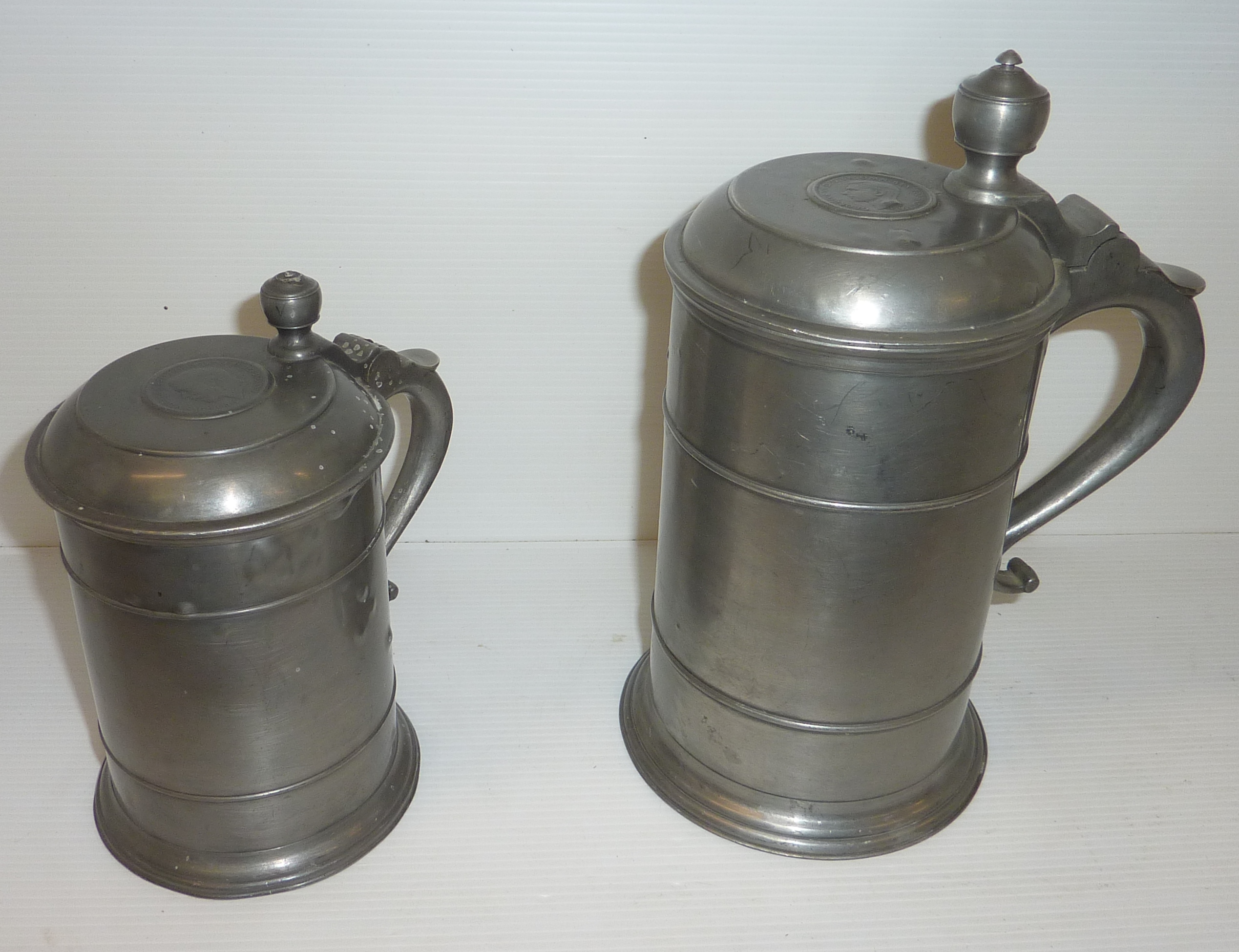 Pewter tankard with impressed marks and the top inset with George VI coin and another similar