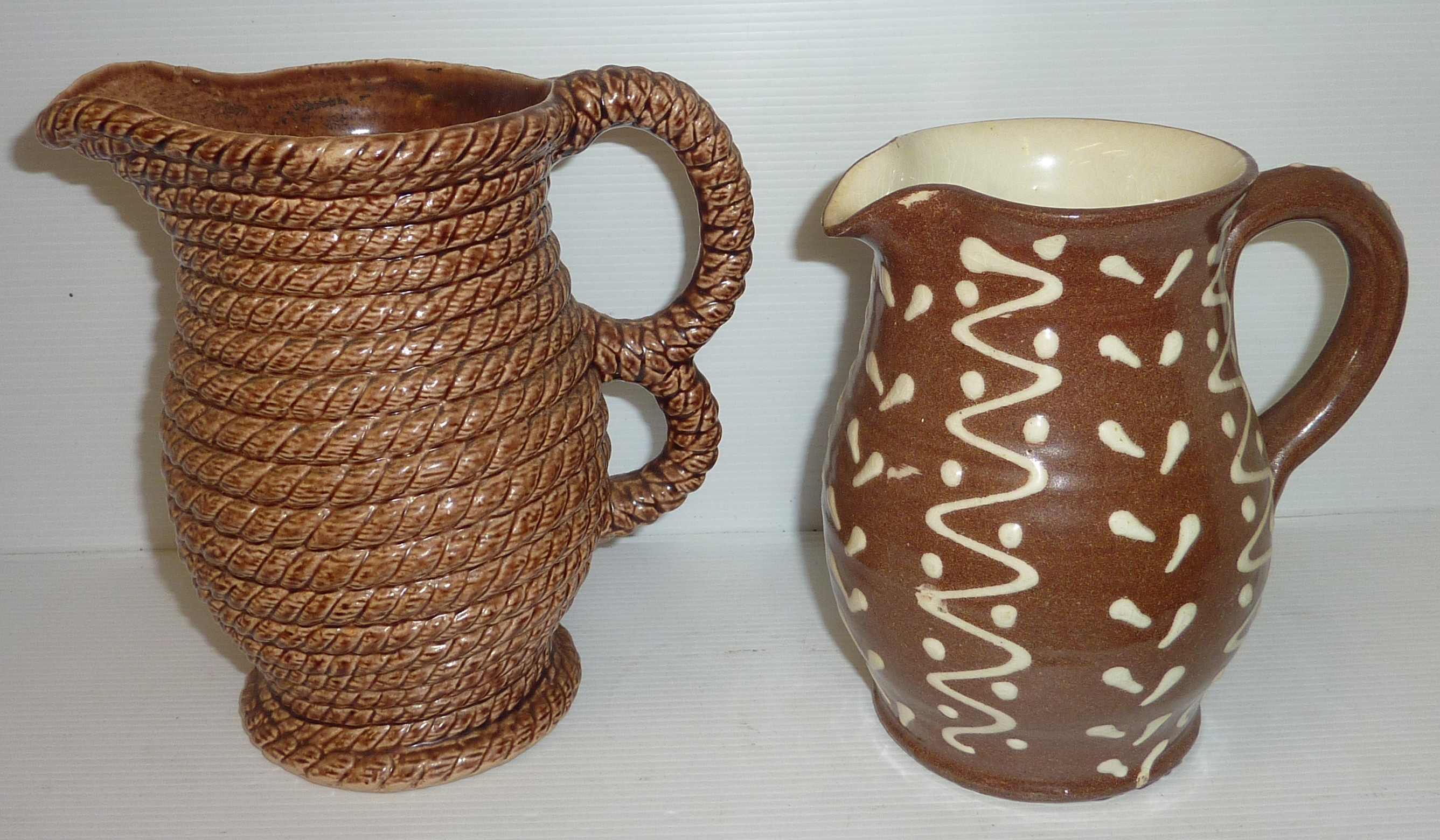 20th C slip ware jug with cream trailed slip decoration and Scottish Govancroft stoneware jug with