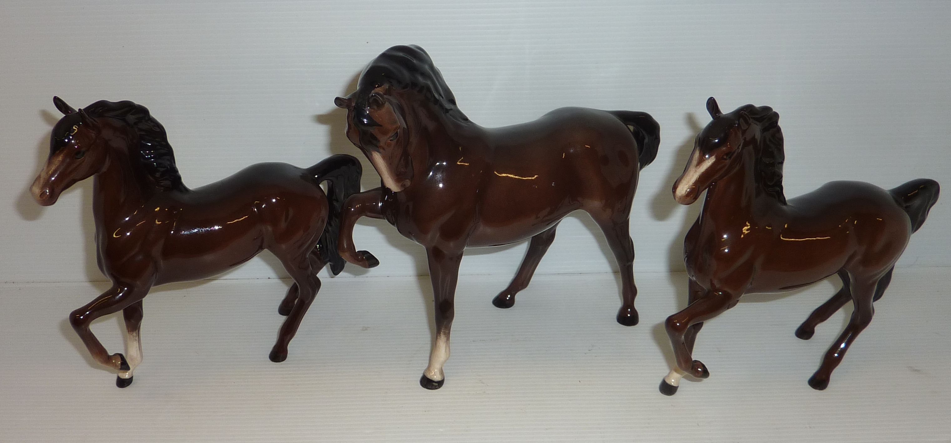 Three Beswick prancing horses