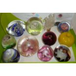 Assorted glass paperweights including Caithness and an opaque glass lidded trinket pot,