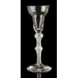An 18th century George III pan shaped drinking glass, circa 1770, with double knopped clear air-