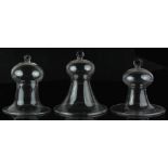 Property of a lady - three clear glass bell shaped cloches, with folded rims & ring handles, the