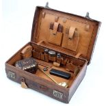 Property of a lady - a leather case & contents including some silver topped fittings (see