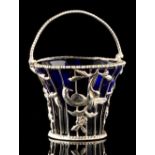 Property of a gentleman - a George III silver pierced basket, with swing handle & blue glass