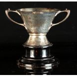 Property of a lady - an Edwardian Arts & Crafts silver two-handled loving cup, with hammered