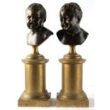 Property of a gentleman - a pair of 19th century patinated & polished bronze heads of infants on