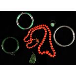 A group of six jewellery items including a graduated coral bead necklace, a Chinese silver bangle,