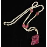 A Chinese pink tourmaline & cultured pearl necklace, the large tourmaline pendant drop carved in the