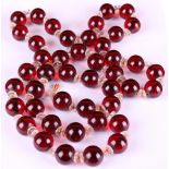 Property of a lady - a cherry amber bead long necklace, the uniform spherical beads approximately