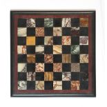 A late 19th century specimen marble chess board, 10.5ins. (26.6cms.) square (see illustration).