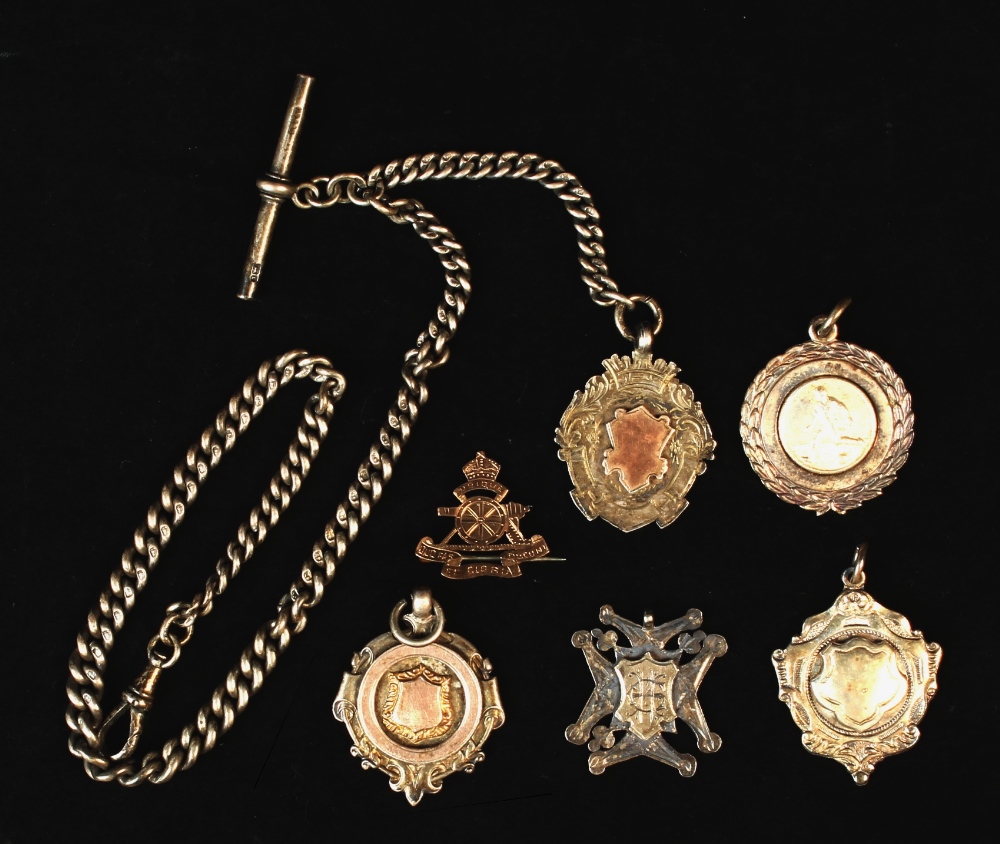 Property of a lady - a 9ct gold Royal Artillery brooch; together with a silver watch chain; and