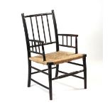 Property of a deceased estate - a late 19th / early 20th century ebonised & rush seated elbow chair,