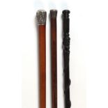 A Chinese silver topped malacca walking cane; together with another silver topped cane; and an