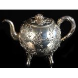 Property of a lady - a late 19th / early 20th century Chinese silver teapot, decorated in relief