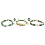 A bag containing two jadeite rings; together with two jadeite bangles, one with 14ct gold mounts;