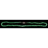 A Chinese jadeite graduated bead necklace, the eighty-three untreated jadeite round beads ranging