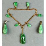 A Chinese gold chain bracelet with seven carved jadeite drops; together with two jadeite drop