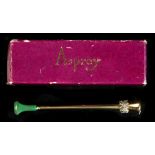 A boxed Asprey 18ct yellow gold cigarette holder with emerald & diamond collar, 3.45ins. (8.8cms.)