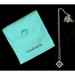 A Tiffany & Co. platinum ruby & diamond pendant on platinum chain necklace, the pendant with