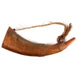 A carved buffalo horn, 19th century, probably Indonesian, on carved wood base, the horn 14.2ins. (