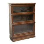 Property of a lady - a Globe Wernicke oak three-section stacking bookcase, 34ins. (86.5cms.) wide (