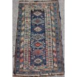 Property of a deceased estate - an early 20th century Shirvan rug, with navy field, dated 1334 (