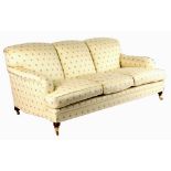 Property of a lady - a George Smith sofa, in the style of Howard, with turned front legs terminating