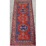 Property of a deceased estate - a Turkish Caucasian style long rug with red field, 129 by 52ins. (