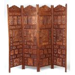 Property of a gentleman - a late 19th / early 20th century Indian carved hardwood four-panel screen,