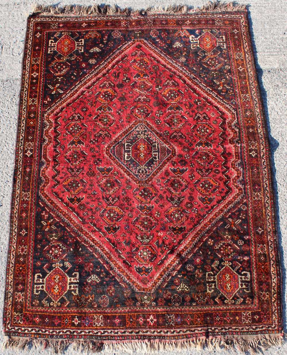 Property of a gentleman - a mid 20th century Shiraz rug with red ground, 96 by 69ins. (244 by