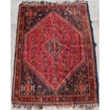 Property of a gentleman - a mid 20th century Shiraz rug with red ground, 96 by 69ins. (244 by