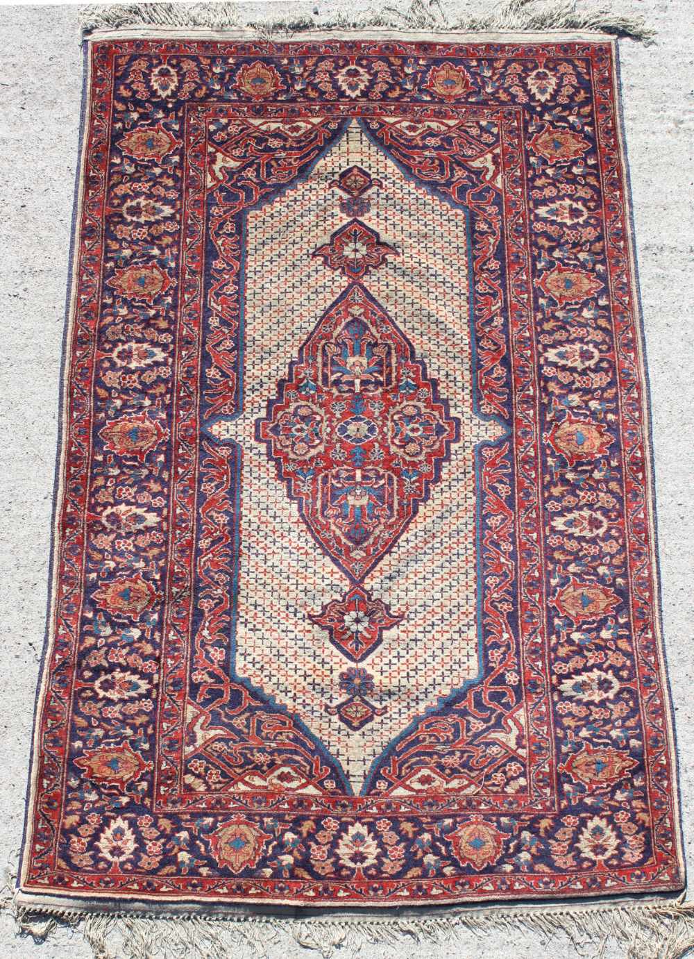 Property of a deceased estate - an early 20th century Tabriz rug, with large ivory medallion on navy