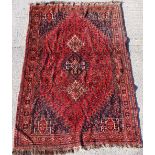 Property of a gentleman - a mid 20th century Qashgai carpet with red ground & navy spandrels, 115 by