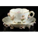 Property of a lady - a late 19th century Meissen floral encrusted porcelain cup & saucer, painted