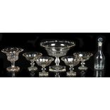 A late Victorian cut glass pedestal dish, 11.8ins. (30cms.) across; together with a similar set of