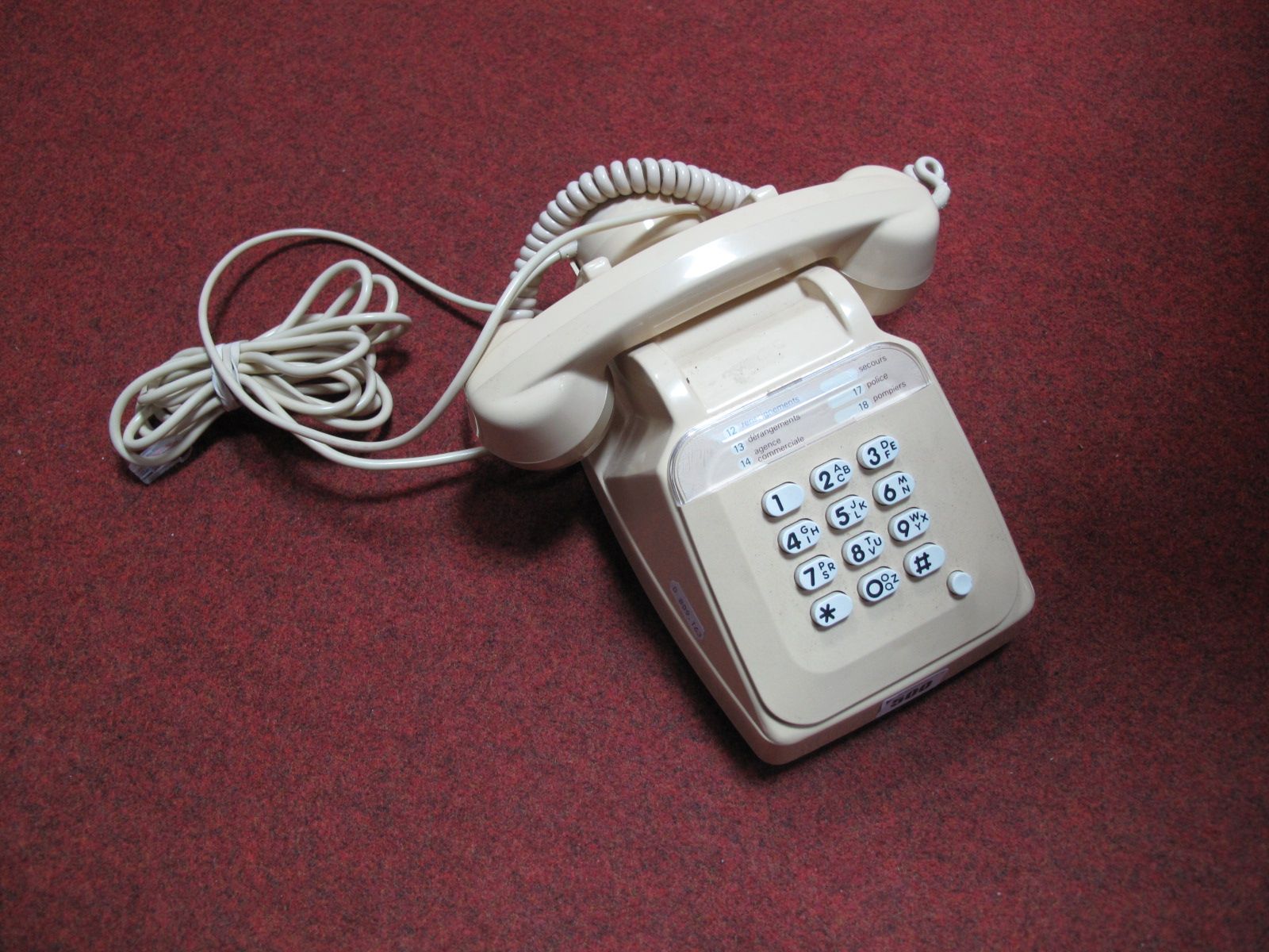 A Cream Coloured Late XX Century French Push Button Telephone, with separate speaker in cradle,