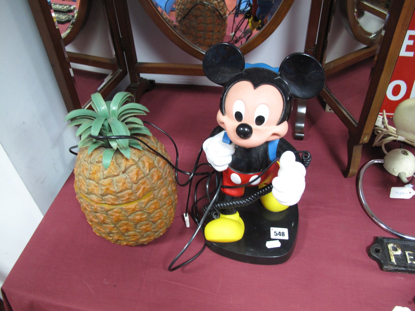 A Novelty Telephone Modelled as a Walking Mickey Mouse with Backpack, and a plastic pineapple ice