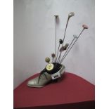 An Edwardian Novelty Hat Pin Holder, as a pewter lady's shoe, dated 1915, along with a silver hat