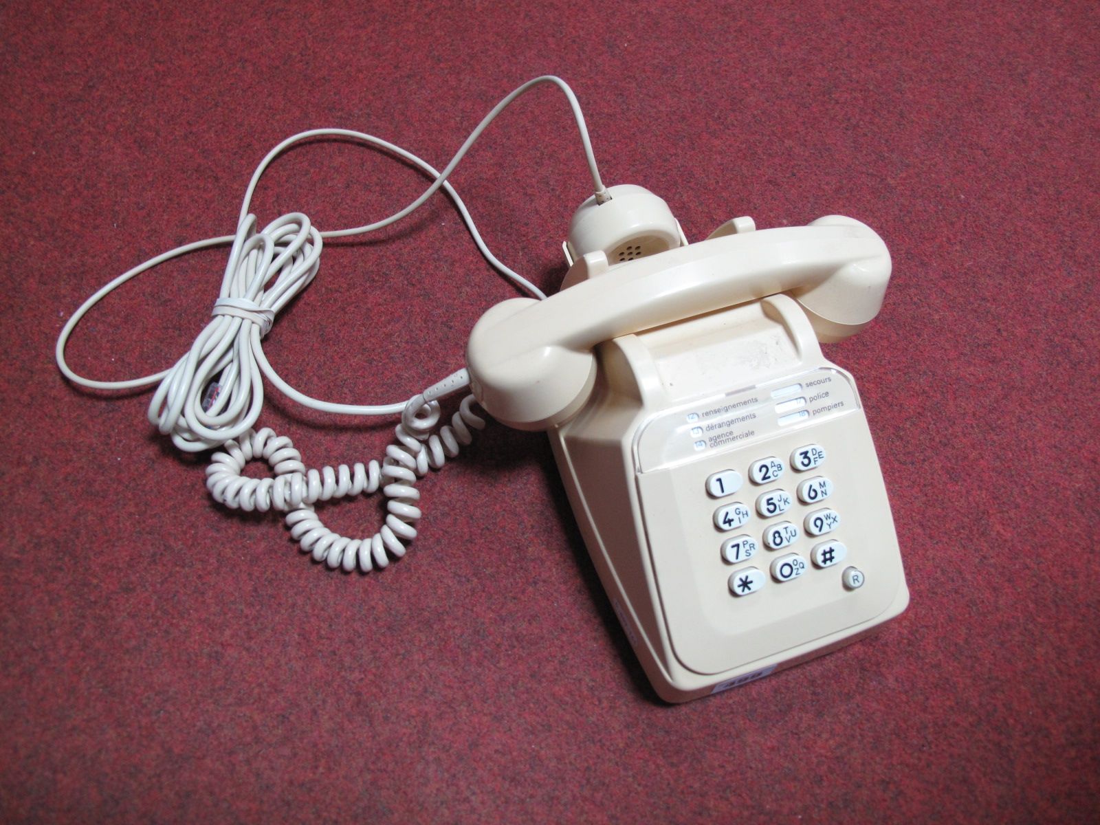 A Cream Coloured Late XX Century French Push Button Telephone, with separate speaker in cradle,