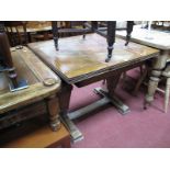 Oak Draw Leaf table, on twin tapering carved pedestals, with platform bases, united by stretcher.