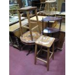 An Indian Hardwood Tripod Table, circular top with carved foliate reserves around central inlaid