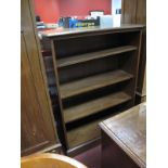 A Modern Mahogany Effect Four Tier Bookshelf, on plinth base.