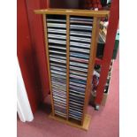 Approximately Eighty CD's, of eclectic genres all in wooden CD rack.