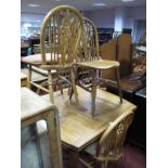 An Oak Circa 1960's D-Ended Extending Dining Table, together with four farmhouse style spindle